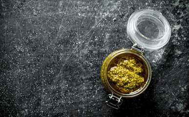 Pesto sauce in a glass jar.