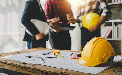 Engineers work as a team with blueprints for architectural plans. Engineer sketching construction project concept with architect equipment Architects talking at table Teamwork and construction concept