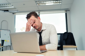 Fototapeta premium Unemployment problem concept, financial problems no debt payment Stressed young man in workplace, getting bad news. Failed exams. Sad and stressed businessman because he got fired from his job.