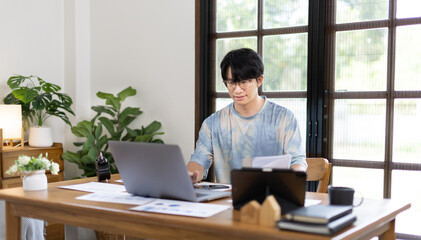 College student is analyzing data or doing homework assignments in own house, Work from home, Use your laptop to search for information and educate yourself at home, Stay home, Internet learning.