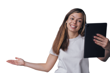 Excited Spanish brunette young woman holds tablet makes video call broad smiles against transparent background. Cheerful Italian girl enjoys leisure, points view on background behind her via internet
