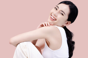 Studio shot of Beautiful young Asian woman with clean fresh skin on pink background, Face care,...