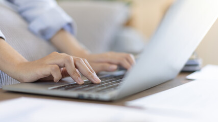 Close-up shot of young woman's hand pressing on laptop keyboard, Use of computers to process data for speed and accuracy, Using a laptop to conduct transactions because it is convenient and fast.