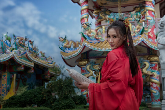 woman in Chinese traditional dress on temple background. woman in traditional Chinese clothes. traditional Chinese, Beautiful girl in red traditional Chinese dress.