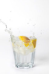 Fototapeta na wymiar Glass of lemonade with splashing water on white background with copy space