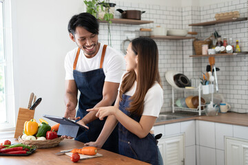 Couple cooking together. Happy young couple cooking together in the kitchen. valentine day concept.