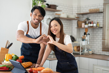 Couple cooking together. Happy young couple cooking together in the kitchen. valentine day concept.