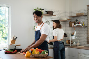 Couple cooking together. Happy young couple cooking together in the kitchen. valentine day concept.