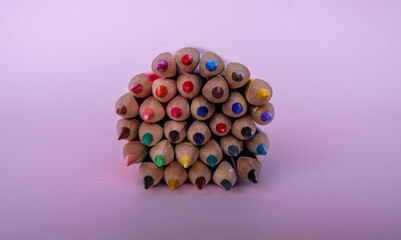 Colorful pencils tips on pink background