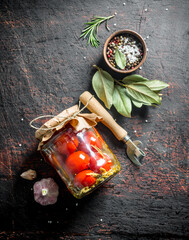 Jar of pickled tomatoes.