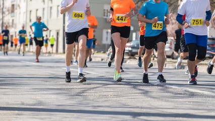 Marathon running race, people feet on road.