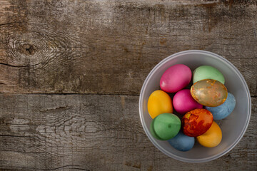 Easter eggs in a cup on a rustic background, top view of Easter eggs, space for text, copy space