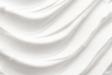 Texture of white face cream is smeared. Cosmetic products for makeup and skin care