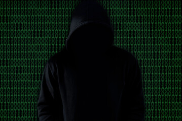 Asian hacker in black hood on black background,Hack password,hacking safety systems to steal information