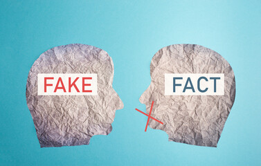 Fake or fact on a head, false and truth information, propaganda and conspiracy theory concept,...