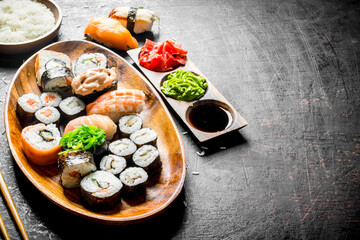 Traditional Japanese sushi and rolls with soy sauce and ginger.