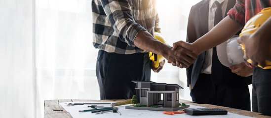 Group of industrial engineering technicians, male and female workers of various nationalities join forces for success, teamwork and unity