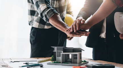 Group of industrial engineering technicians, male and female workers of various nationalities join forces for success, teamwork and unity