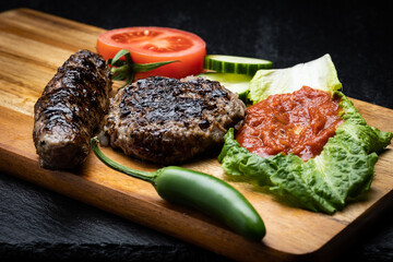 Typical Bulgarian barbecue dish consisting of kyufte, kebapche and lutenica