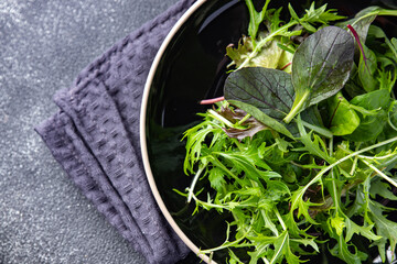 Healthy green salad leaves mix micro green, juicy snack food on the table copy space food background rustic top view