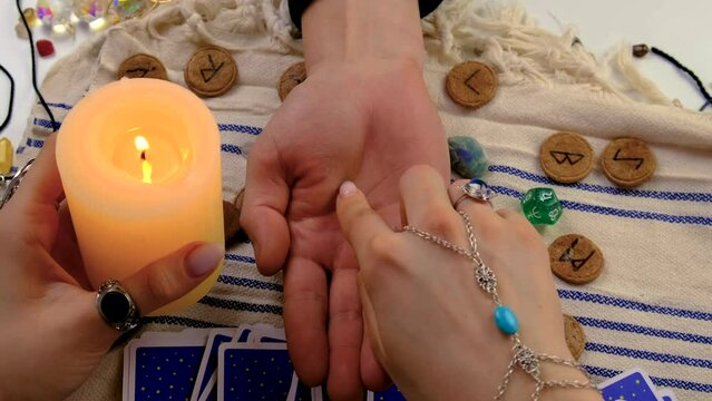 A fortune teller reads with tarot cards. Selective focus.