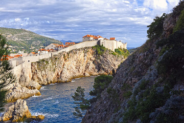 Dubrovnik West Harbor and view to the ancient city wall on the rocks, Dubrovnik, Croatia
