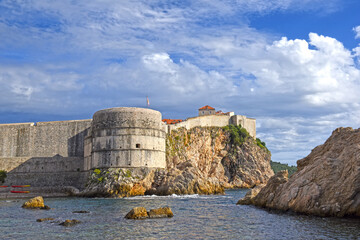 Dubrovnik West Harbor and view to the ancient city wall on the rocks, Dubrovnik, Croatia