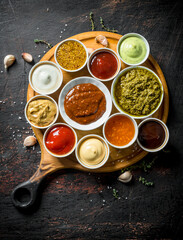 Obraz na płótnie Canvas Pesto sauce, mustard, barbecue sauce, mayonnaise with garlic slices.