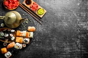 Delicious sushi rolls and fragrant green tea.