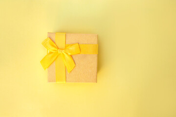 yellow gift box isolated on yellow background 