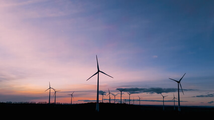 wind turbines under the beautiful sky at sunset