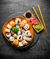 Japanese maki, rolls and sushi with ginger, soy sauce and wasabi.