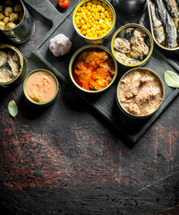 Assortment of various canned food in open cans.