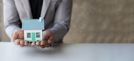 Real estate agent Delivering sample homes to customers, mortgage loan contracts. Make a contract for hire purchase and sale of a house. and home insurance contracts, home mortgage loan concepts.