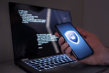 Cyber security in phone and laptop to protect from fraud, cybersecurity attack or identity theft....