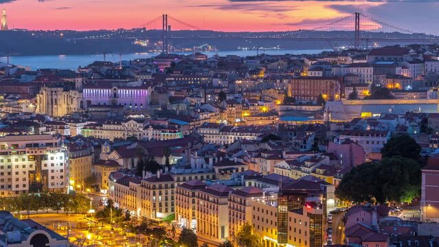Lisbon after sunset aerial panoramic view of city centre with red roofs at autumn day to night transition timelapse, Portugal. Top view from Miradouro da Nossa Senhora do Monte viewpoint