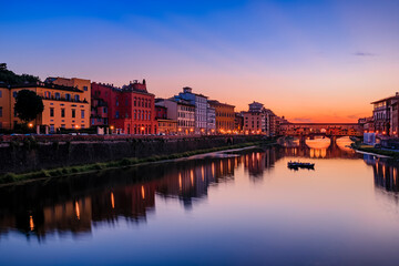 Fototapeta na wymiar Famous Ponte Vecchio bridge on the river Arno River at sunset, Florence, Italy