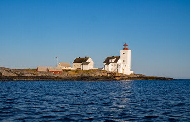 Fototapeta na wymiar Lighthouse in south of Norway, Homborsund at the summer with blue sky and a clear view