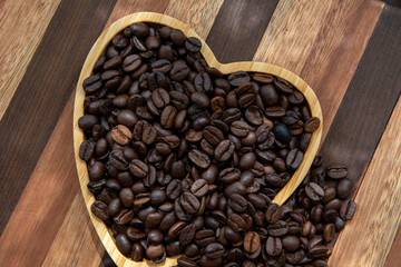 coffee beans in heart-shaped tra,y representing love of coffee