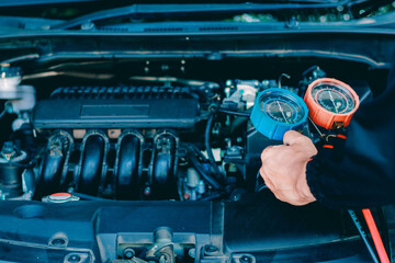 car service worker repairing vehicle , For customers who use cars for repair services .