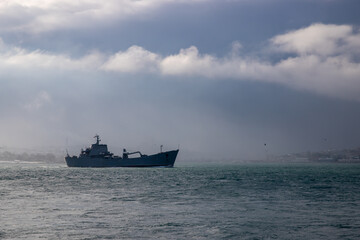 military ship cruising in istanbul marmara sea and cloudy weather , military ship standing alone