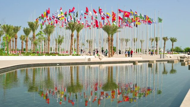 Flags of different countries in front of  the lake. Flag Plaza, Doha, Qatar. Middle East architecture. Outdoors