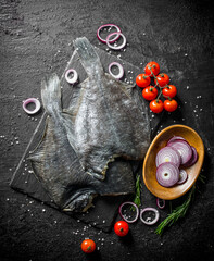 Raw flounder with cherry tomatoes and chopped onion in bowl.