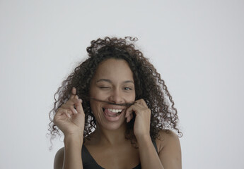 ECU Headshot portrait of beautiful 20s African-American Black female posing and doing silly faces...