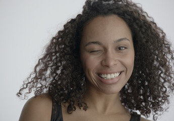 ECU Headshot portrait of beautiful 20s African-American Black female posing against white...