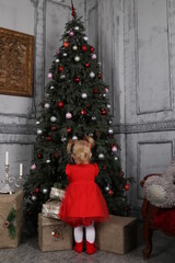 parent and child decorating christmas tree