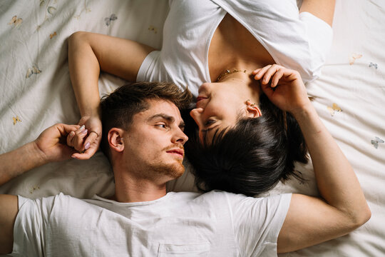 Loving couple lying on bed