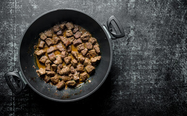 Fried liver in a pan.