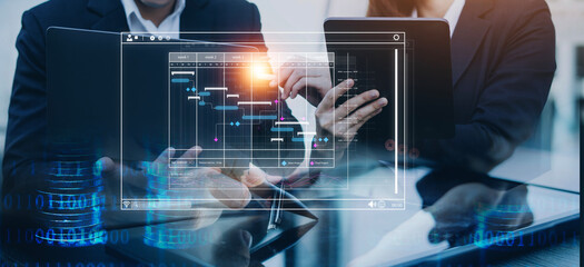 Analyst working with computer in Business Analytics and Data Management System to make report with KPI and metrics connected to database. Corporate strategy for finance, operations, sales, marketing.