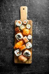Freshly cooked sushi rolls on a cutting Board.